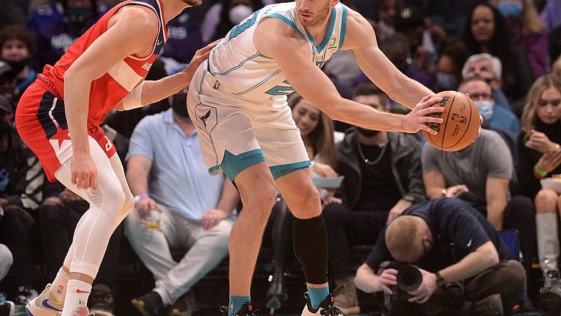 Nov 17, 2021; Charlotte, North Carolina, USA; Charlotte Hornets guard forward Gordon Hayward (20) looks to pass as he is defended by Washington Wizards forward Deni Avdija (9) during the first half at the Spectrum Center. Mandatory Credit: Sam Sharpe-USA TODAY Sports