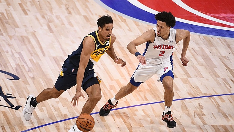 Nov 17, 2021; Detroit, Michigan, USA; Indiana Pacers guard Malcolm Brogdon (7) drives to the basket as Detroit Pistons guard Cade Cunningham (2) defends during the second quarter at Little Caesars Arena. Mandatory Credit: Tim Fuller-USA TODAY Sports