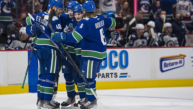 Nov 19, 2021; Vancouver, British Columbia, CAN; Vancouver Canucks forward Elias Pettersson (40) and  defenseman Oliver Ekman-Larsson (23) and forward Juho Lammikko (91) and forward Nils Hoglander (21) and  forward Brock Boeser (6) celebrate Ekman-Larsson s goal against the Winnipeg Jets in the first period at Rogers Arena. Mandatory Credit: Bob Frid-USA TODAY Sports