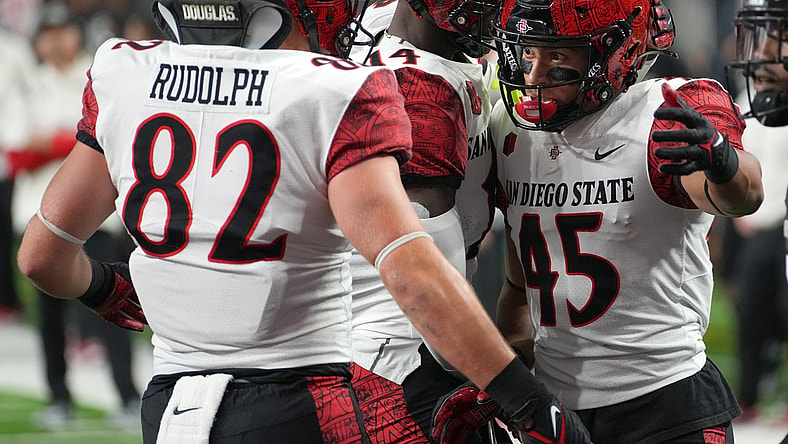 Nov 19, 2021; Paradise, Nevada, USA; San Diego State Aztecs wide receiver Jesse Matthews (45) celebrates with San Diego State Aztecs tight end Jay Rudolph (82) and San Diego State Aztecs wide receiver Tyrell Shavers (14) after scoring a touchdown against the UNLV Rebels at Allegiant Stadium. Mandatory Credit: Stephen R. Sylvanie-USA TODAY Sports