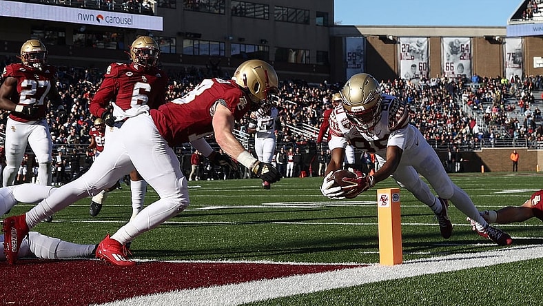 Nov 20, 2021; Chestnut Hill, Massachusetts, USA; Florida State Seminoles wide receiver Ontaria Wilson (80) dives to the goalie for a touchdown before Boston College Eagles defensive back Mike Palmer (18) can get there during the first half at Alumni Stadium. Mandatory Credit: Winslow Townson-USA TODAY Sports