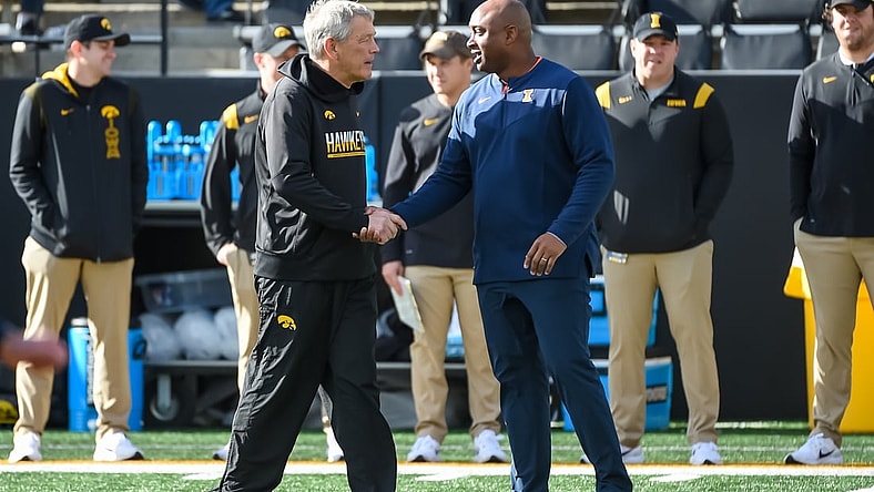 Nov 20, 2021; Iowa City, Iowa, USA;  Iowa Hawkeyes head coach Kirk Ferentz and Illinois Fighting Illini acting head coach George McDonald meet before the game at Kinnick Stadium. Mandatory Credit: Steven Branscombe-USA TODAY Sports