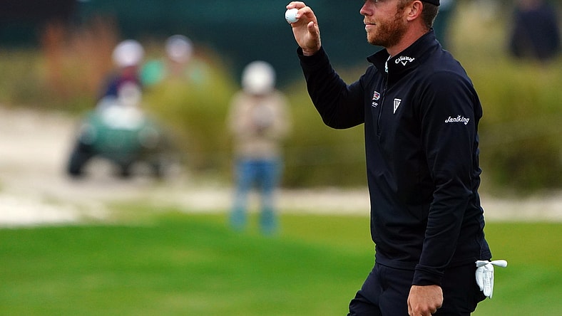 Nov 20, 2021; Sea Island, Georgia, USA; Talor Gooch waves to the gallery after his putt on the 18th green during the third round of the RSM Classic golf tournament at Sea Island Golf Club - Seaside Course. Mandatory Credit: John David Mercer-USA TODAY Sports