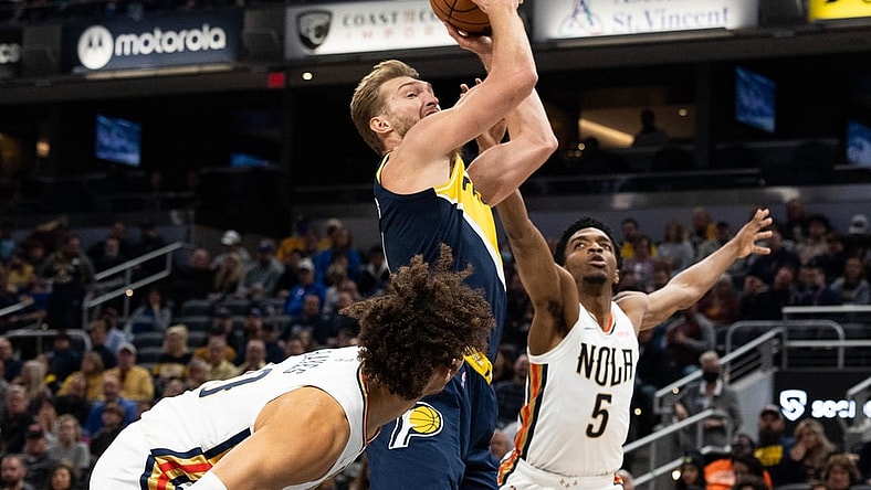 Nov 20, 2021; Indianapolis, Indiana, USA; Indiana Pacers forward Domantas Sabonis (11) shoots the ball and is fouled by New Orleans Pelicans forward Herbert Jones (5) in the first half at Gainbridge Fieldhouse. Mandatory Credit: Trevor Ruszkowski-USA TODAY Sports