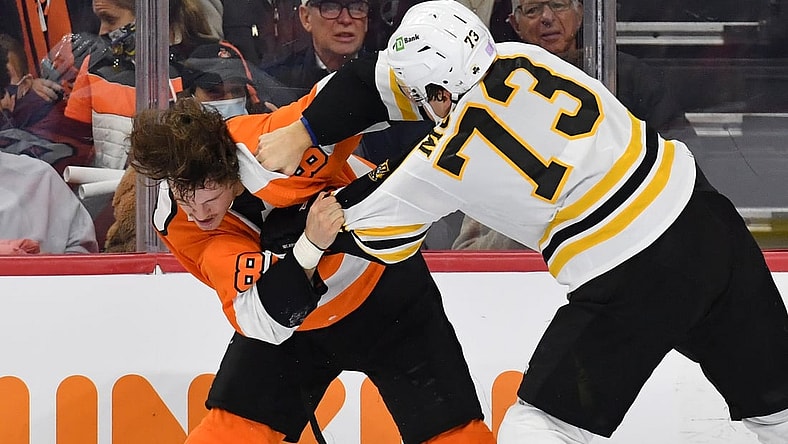 Nov 20, 2021; Philadelphia, Pennsylvania, USA; Philadelphia Flyers left wing Joel Farabee (86) fights with Boston Bruins defenseman Charlie McAvoy (73) during the second period at Wells Fargo Center. Mandatory Credit: Eric Hartline-USA TODAY Sports