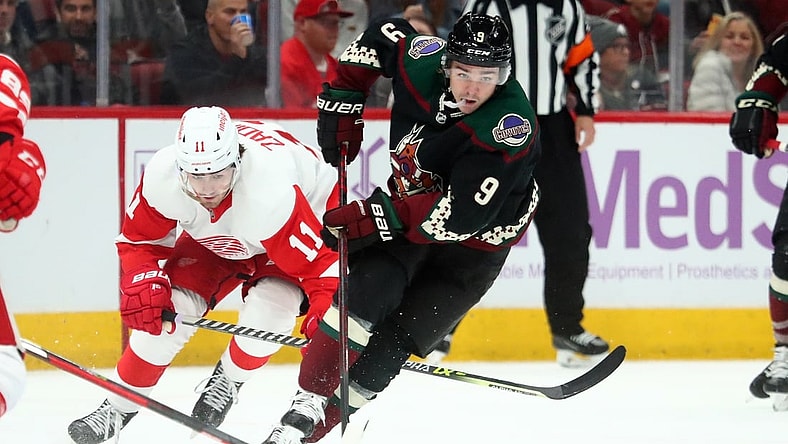 Nov 20, 2021; Glendale, Arizona, USA; Arizona Coyotes right wing Clayton Keller (9) moves the puck against the Detroit Red Wings in the second period at Gila River Arena. Mandatory Credit: Mark J. Rebilas-USA TODAY Sports