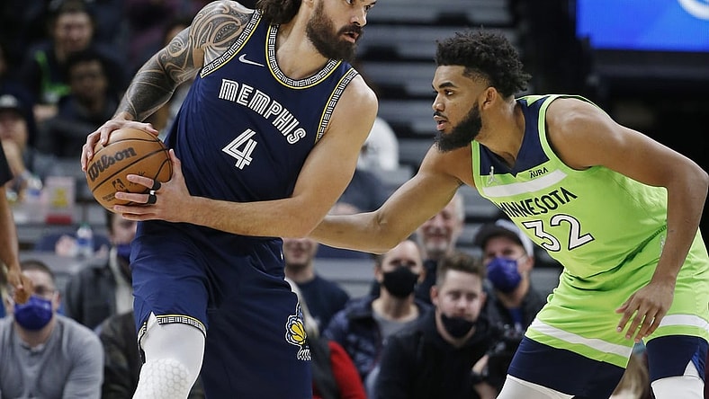 Nov 20, 2021; Minneapolis, Minnesota, USA; Minnesota Timberwolves center Karl-Anthony Towns (32) defends against Memphis Grizzlies center Steven Adams (4) in the first quarter at Target Center. Mandatory Credit: Bruce Kluckhohn-USA TODAY Sports