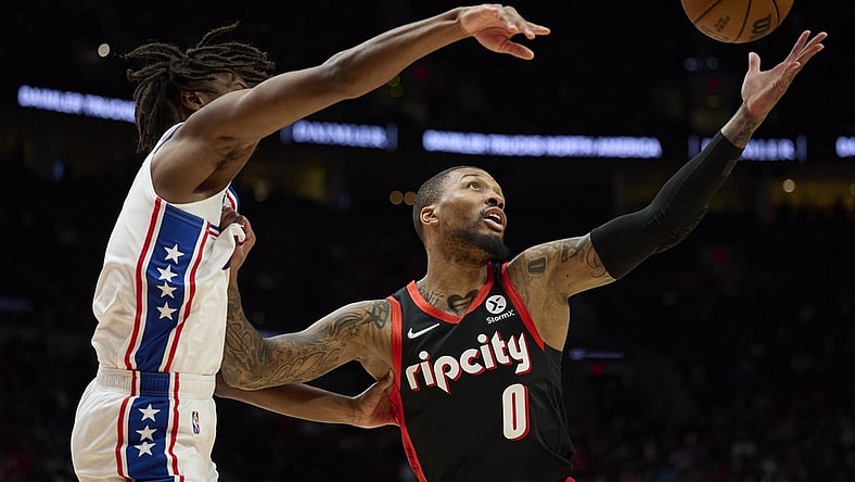 Nov 20, 2021; Portland, Oregon, USA; Philadelphia 76ers guard Tyrese Maxey (0) defends Portland Trail Blazers guard Damian Lillard (0) during the first half at Moda Center. Mandatory Credit: Troy Wayrynen-USA TODAY Sports
