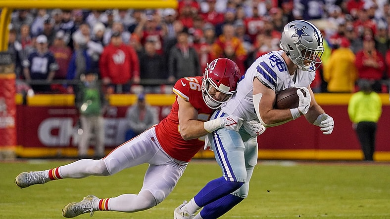 Nov 21, 2021; Kansas City, Missouri, USA; Dallas Cowboys tight end Dalton Schultz (86) catches a pass as Kansas City Chiefs outside linebacker Ben Niemann (56) makes the tackle during the first half at GEHA Field at Arrowhead Stadium. Mandatory Credit: Denny Medley-USA TODAY Sports