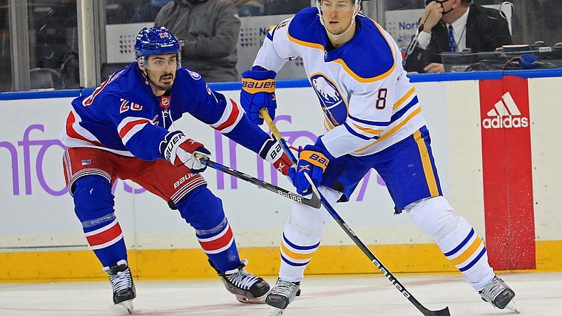 Nov 21, 2021; New York, New York, USA; New York Rangers left wing Chris Kreider (20) and Buffalo Sabres defenseman Robert Hagg (8) battle for the puck during the first period at Madison Square Garden. Mandatory Credit: Danny Wild-USA TODAY Sports