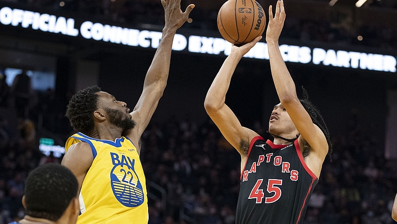 November 21, 2021; San Francisco, California, USA; Toronto Raptors guard Dalano Banton (45) shoots the basketball against Golden State Warriors forward Andrew Wiggins (22) during the second quarter at Chase Center. Mandatory Credit: Kyle Terada-USA TODAY Sports