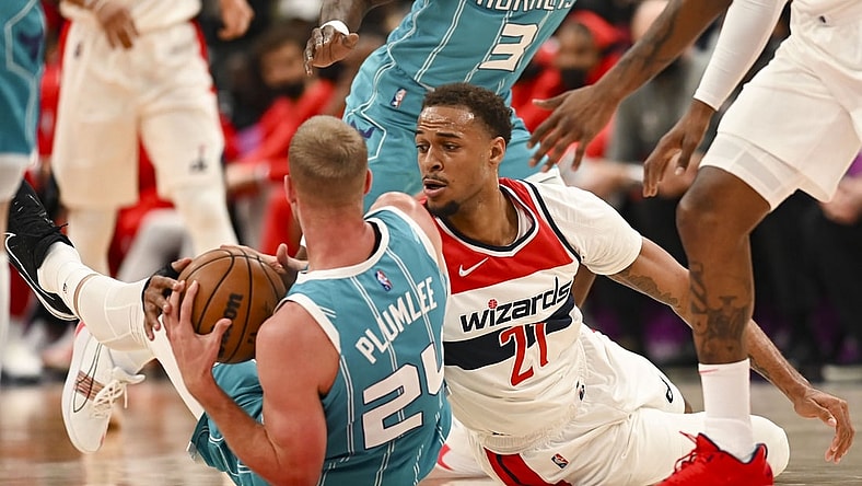 Nov 22, 2021; Washington, District of Columbia, USA;  Charlotte Hornets center Mason Plumlee (24) and Washington Wizards center Daniel Gafford (21) battle for a loose ball during the first half at Capital One Arena. Mandatory Credit: Tommy Gilligan-USA TODAY Sports