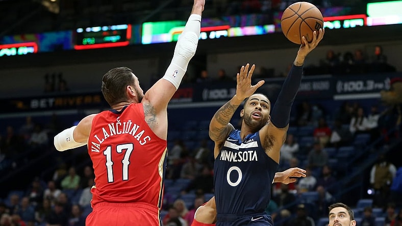 Nov 22, 2021; New Orleans, Louisiana, USA; Minnesota Timberwolves guard D'Angelo Russell (0) shoots while defended by New Orleans Pelicans center Jonas Valanciunas (17) in the first quarter at the Smoothie King Center. Mandatory Credit: Chuck Cook-USA TODAY Sports