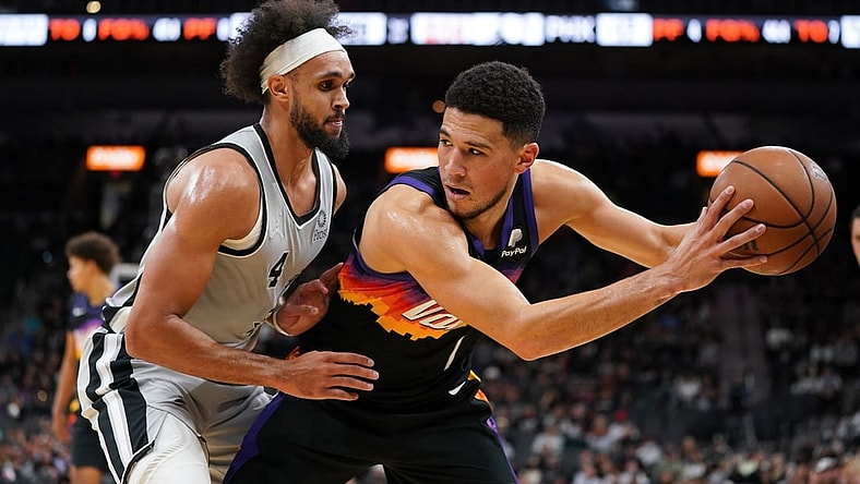 Nov 22, 2021; San Antonio, Texas, USA;  Phoenix Suns guard Devin Booker (1) backs in to San Antonio Spurs guard Derrick White (4) in the first half at the AT&T Center. Mandatory Credit: Daniel Dunn-USA TODAY Sports