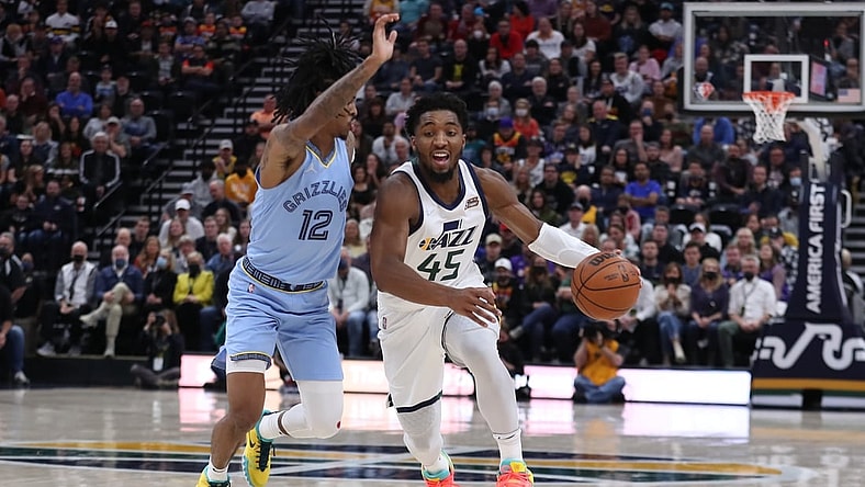 Nov 22, 2021; Salt Lake City, Utah, USA; Utah Jazz guard Donovan Mitchell (45) bring the ball up the court defended by Memphis Grizzlies guard Ja Morant (12) in the second quarter at Vivint Arena. Mandatory Credit: Rob Gray-USA TODAY Sports