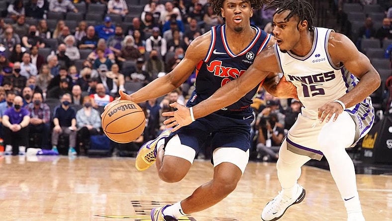 Nov 22, 2021; Sacramento, California, USA; Philadelphia 76ers guard Tyrese Maxey (0) drives in against Sacramento Kings guard Davion Mitchell (15) during the second quarter at Golden 1 Center. Mandatory Credit: Kelley L Cox-USA TODAY Sports