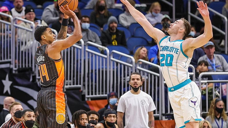 Nov 24, 2021; Orlando, Florida, USA; Orlando Magic guard Gary Harris (14) shoots the ball against Charlotte Hornets forward Gordon Hayward (20) during the first quarter at Amway Center. Mandatory Credit: Mike Watters-USA TODAY Sports