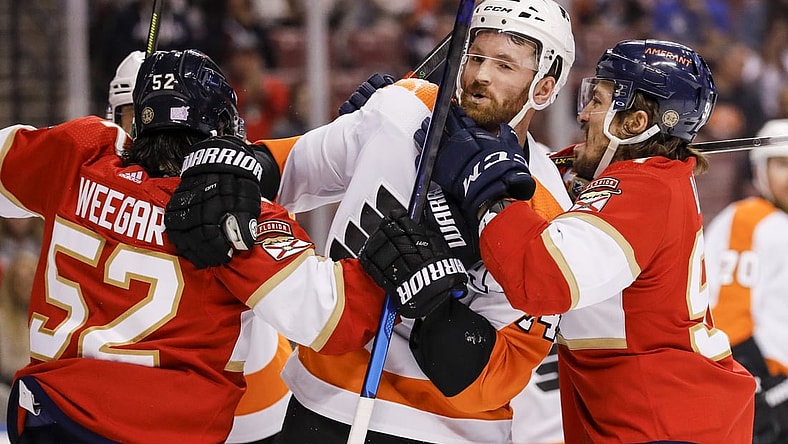 Nov 24, 2021; Sunrise, Florida, USA; Florida Panthers defenseman MacKenzie Weegar (52) pushes Philadelphia Flyers center Sean Couturier (14) during the first period at FLA Live Arena. Mandatory Credit: Sam Navarro-USA TODAY Sports