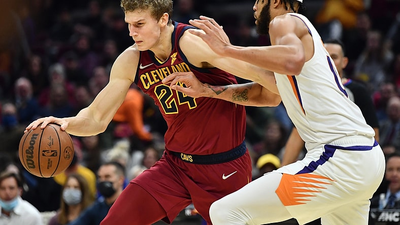 Nov 24, 2021; Cleveland, Ohio, USA; Cleveland Cavaliers forward Lauri Markkanen (24) drives to the basket against Phoenix Suns center JaVale McGee (00) during the first half at Rocket Mortgage FieldHouse. Mandatory Credit: Ken Blaze-USA TODAY Sports