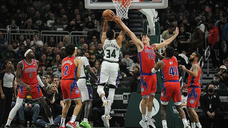 Nov 24, 2021; Milwaukee, Wisconsin, USA; Milwaukee Bucks forward Giannis Antetokounmpo (34) puts up a shot against Detroit Pistons center Luka Garza (55) in the first half at Fiserv Forum. Mandatory Credit: Michael McLoone-USA TODAY Sports