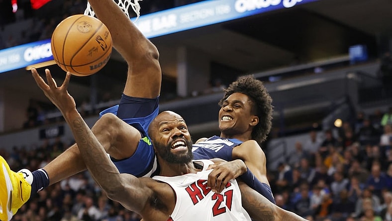 Nov 24, 2021; Minneapolis, Minnesota, USA; Minnesota Timberwolves forward Jaden McDaniels (3) fouls Miami Heat center Dewayne Dedmon (21) in the first quarter at Target Center. Mandatory Credit: Bruce Kluckhohn-USA TODAY Sports