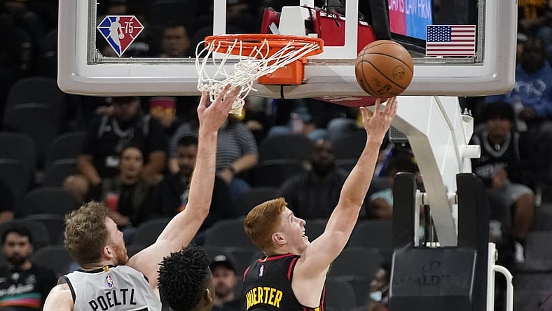 Nov 24, 2021; San Antonio, Texas, USA; Atlanta Hawks guard Kevin Huerter (3) drives to the basket past San Antonio Spurs center Jakob Poeltl (25) during the first half at AT&T Center. Mandatory Credit: Scott Wachter-USA TODAY Sports
