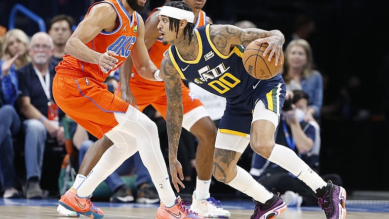 Nov 24, 2021; Oklahoma City, Oklahoma, USA; Utah Jazz guard Jordan Clarkson (00) drives to the basket around Oklahoma City Thunder forward Kenrich Williams (34) during the first half at Paycom Center. Mandatory Credit: Alonzo Adams-USA TODAY Sports