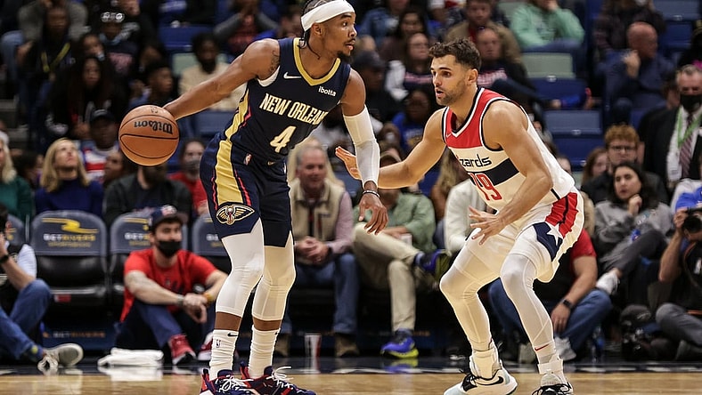 Nov 24, 2021; New Orleans, Louisiana, USA;  New Orleans Pelicans guard Devonte' Graham (4) looks to pass the ball against Washington Wizards guard Raul Neto (19) during the first half at Smoothie King Center. Mandatory Credit: Stephen Lew-USA TODAY Sports