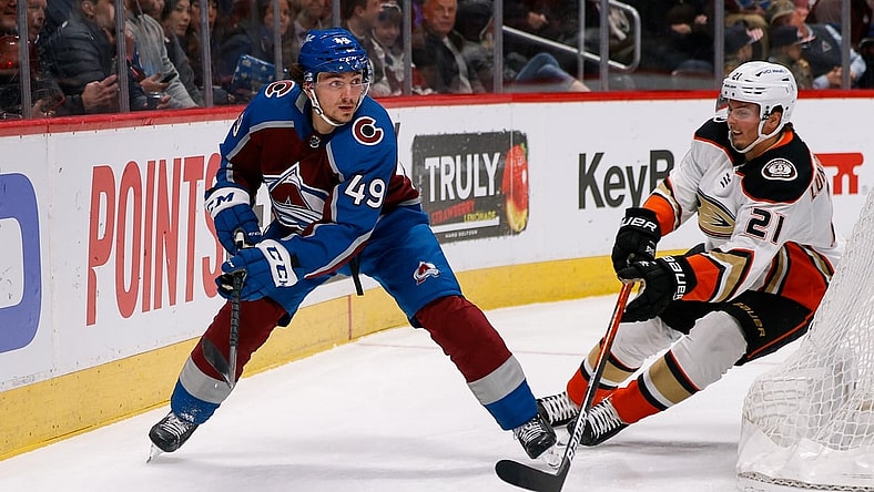 Nov 24, 2021; Denver, Colorado, USA; Colorado Avalanche defenseman Samuel Girard (49) controls the puck ahead of Anaheim Ducks center Isac Lundestrom (21) in the first period at Ball Arena. Mandatory Credit: Isaiah J. Downing-USA TODAY Sports