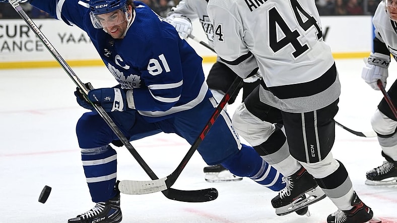 Nov 24, 2021; Los Angeles, California, USA; Toronto Maple Leafs center John Tavares (91) and Los Angeles Kings defenseman Mikey Anderson (44) battle for the puck in the first period at Staples Center. Mandatory Credit: Jayne Kamin-Oncea-USA TODAY Sports