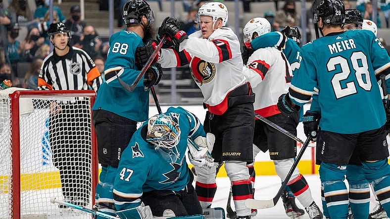 Nov 24, 2021; San Jose, California, USA;  San Jose Sharks defenseman Brent Burns (88) and Ottawa Senators left wing Brady Tkachuk (7) fight in front of the net during the first period at SAP Center at San Jose. Mandatory Credit: Neville E. Guard-USA TODAY Sports