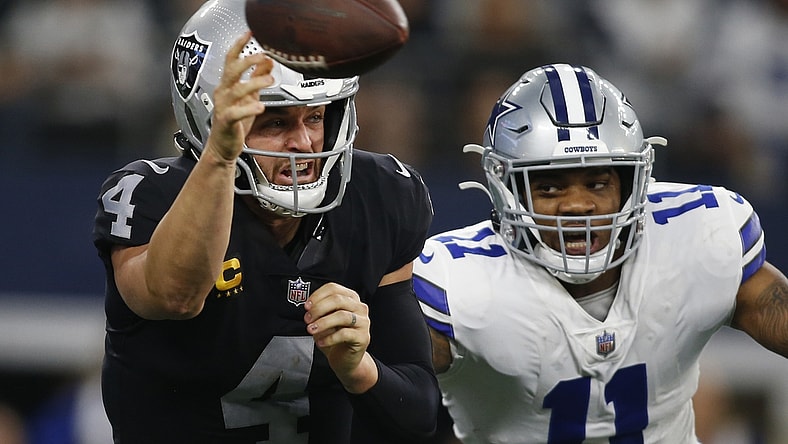Nov 25, 2021; Arlington, Texas, USA; Las Vegas Raiders quarterback Derek Carr (4) throws a pass while Dallas Cowboys outside linebacker Micah Parsons (11) defends in the second quarter at AT&T Stadium. Mandatory Credit: Tim Heitman-USA TODAY Sports