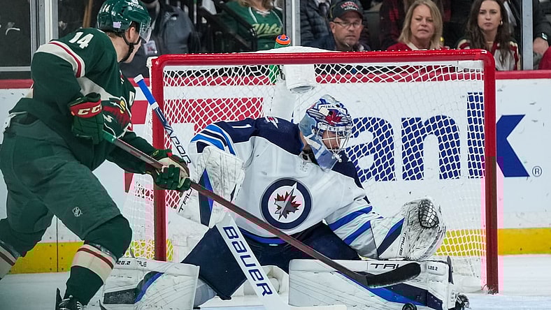 Nov 26, 2021; Saint Paul, Minnesota, USA; Winnipeg Jets goalie Eric Comrie (1) makes a save during the second period against the Minnesota Wild at Xcel Energy Center. Mandatory Credit: Brace Hemmelgarn-USA TODAY Sports