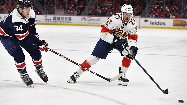Nov 26, 2021; Washington, District of Columbia, USA; Florida Panthers left wing Carter Verhaeghe (23) carries the puck as Washington Capitals defenseman John Carlson (74) defends during the first period at Capital One Arena. Mandatory Credit: Brad Mills-USA TODAY Sports