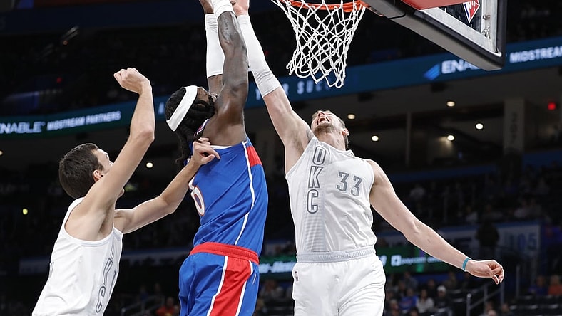 Nov 26, 2021; Oklahoma City, Oklahoma, USA; Oklahoma City Thunder center Mike Muscala (33) blocks a shot by Washington Wizards center Montrezl Harrell (6) during the second quarter at Paycom Center. Mandatory Credit: Alonzo Adams-USA TODAY Sports