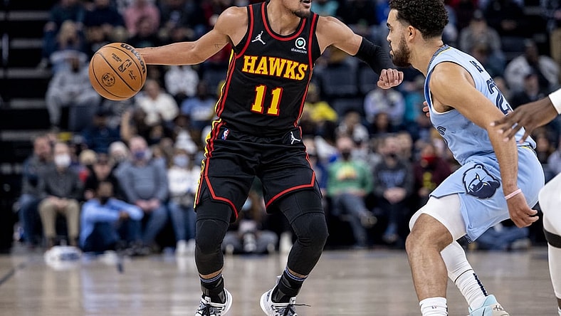 Nov 26, 2021; Memphis, Tennessee, USA; Atlanta Hawks guard Trae Young (11) works around Memphis Grizzlies guard Tyus Jones (21) in the first half at FedExForum. Mandatory Credit: Vasha Hunt-USA TODAY Sports