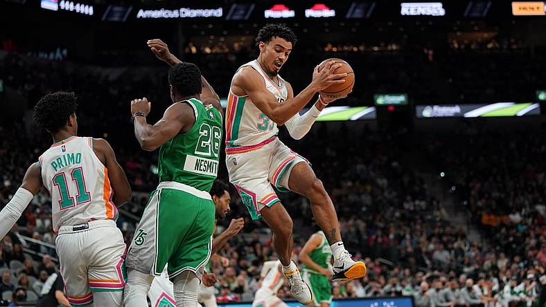 Nov 26, 2021; San Antonio, Texas, USA;  San Antonio Spurs forward Keldon Johnson (3) rebounds in the first half against the Boston Celtics at the AT&T Center. Mandatory Credit: Daniel Dunn-USA TODAY Sports