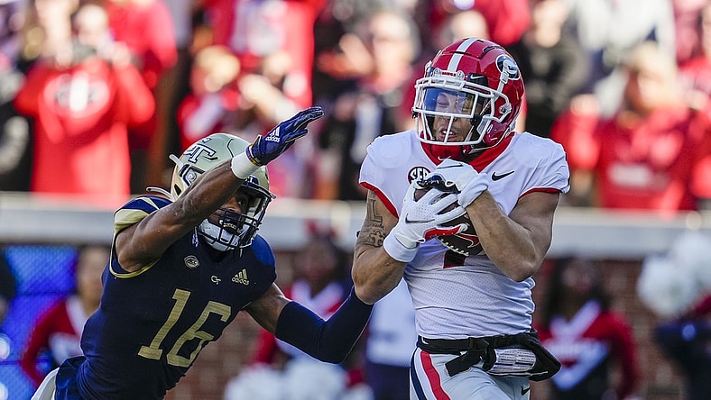 Nov 27, 2021; Atlanta, Georgia, USA; Georgia Bulldogs wide receiver Jermaine Burton (7) catches a touchdown pass behind Georgia Tech Yellow Jackets defensive back Myles Sims (16) during the first quarter at Bobby Dodd Stadium. Mandatory Credit: Dale Zanine-USA TODAY Sports