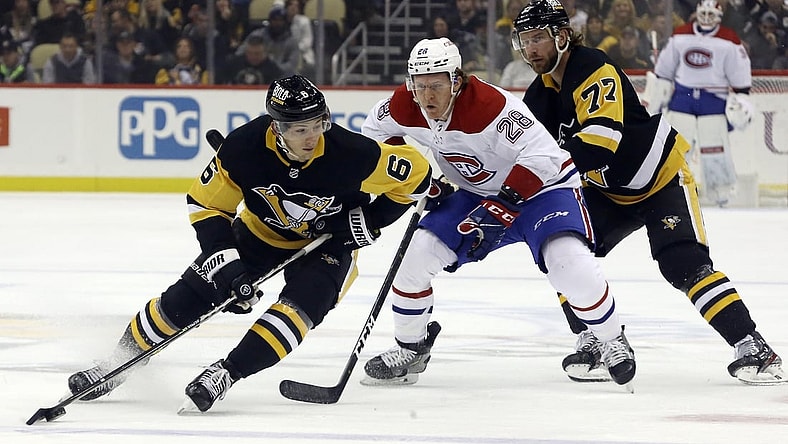 Nov 27, 2021; Pittsburgh, Pennsylvania, USA; Pittsburgh Penguins defenseman John Marino (6) handles the puck against Montreal Canadiens center Christian Dvorak (28) during the first period at PPG Paints Arena. Mandatory Credit: Charles LeClaire-USA TODAY Sports