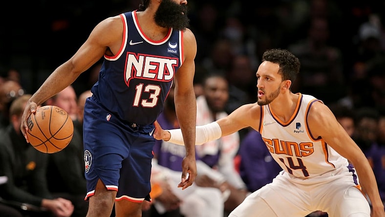 Nov 27, 2021; Brooklyn, New York, USA; Brooklyn Nets guard James Harden (13) controls the ball against Phoenix Suns guard Landry Shamet (14) during the second quarter at Barclays Center. Mandatory Credit: Brad Penner-USA TODAY Sports
