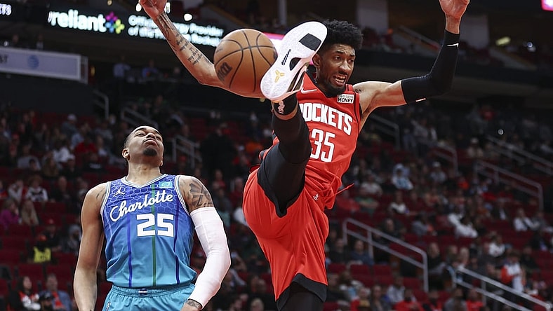 Nov 27, 2021; Houston, Texas, USA; Houston Rockets center Christian Wood (35) dunks the ball as Charlotte Hornets forward P.J. Washington (25) defends during the second quarter at Toyota Center. Mandatory Credit: Troy Taormina-USA TODAY Sports