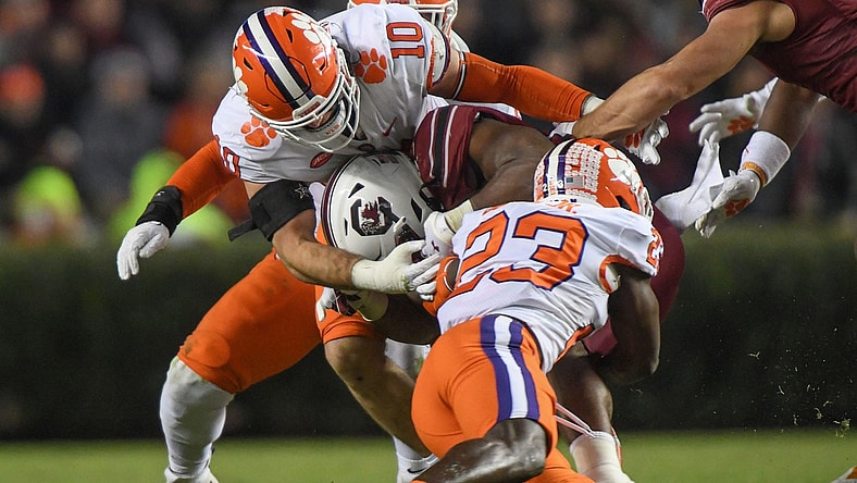 Clemson linebacker Baylon Spector (10) and  cornerback Andrew Booth Jr. (23) sack South Carolina quarterback Jason Brown (15) during the second quarter at Williams Brice Stadium in Columbia, South Carolina Saturday, November 27, 2021.

Clemson U Of Sc Football In Columbia