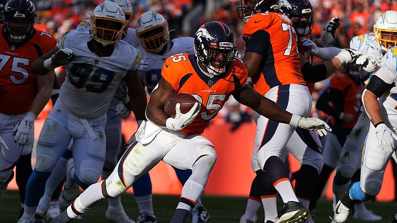 Nov 28, 2021; Denver, Colorado, USA; Denver Broncos running back Melvin Gordon (25) carries the ball in the first half against the Los Angeles Chargers at Empower Field at Mile High. Mandatory Credit: Ron Chenoy-USA TODAY Sports