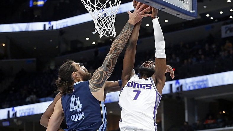 Nov 28, 2021; Memphis, Tennessee, USA; Sacramento Kings forward-center Chimezie Metu (7) shoots as Memphis Grizzles center Steven Adams (4) defends during the first half at FedExForum. Mandatory Credit: Petre Thomas-USA TODAY Sports