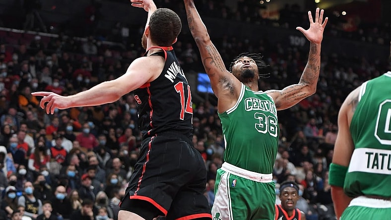 Nov 28, 2021; Toronto, Ontario, CAN;  Boston Celtics guard Marcus Smart (36) contests a rebound with Toronto Raptors guard Svi Mykhailiuk (14) in the first half at Scotiabank Arena. Mandatory Credit: Dan Hamilton-USA TODAY Sports