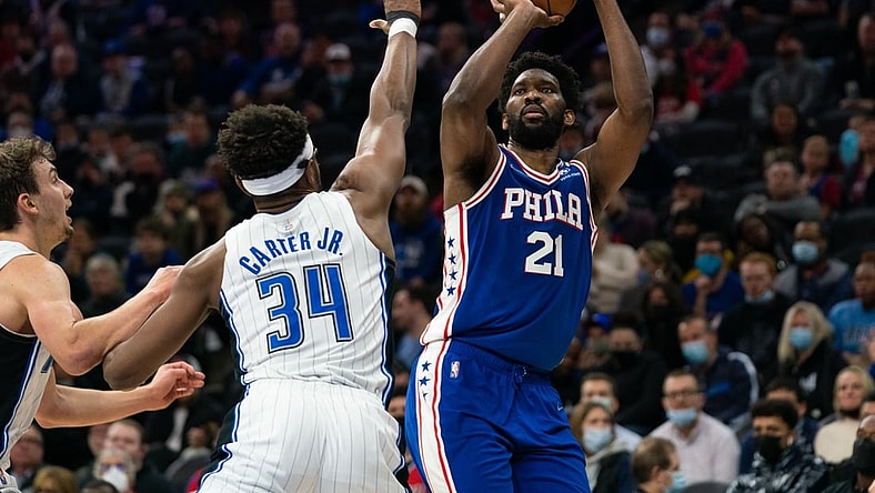 Nov 29, 2021; Philadelphia, Pennsylvania, USA; Philadelphia 76ers center Joel Embiid (21) shoots in front of Orlando Magic center Wendell Carter Jr. (34) during the second quarter at Wells Fargo Center. Mandatory Credit: Bill Streicher-USA TODAY Sports