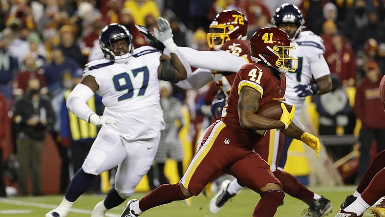 Nov 29, 2021; Landover, Maryland, USA; Washington Football Team running back J.D. McKissic (41) carries the ball past Seattle Seahawks defensive tackle Poona Ford (97) during the first quarter at FedExField. Mandatory Credit: Geoff Burke-USA TODAY Sports