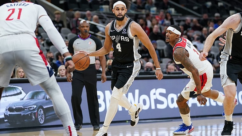 Nov 29, 2021; San Antonio, Texas, USA;  San Antonio Spurs guard Derrick White (4) dribbles past Washington Wizards guard Bradley Beal (3) in the first half at the AT&T Center. Mandatory Credit: Daniel Dunn-USA TODAY Sports
