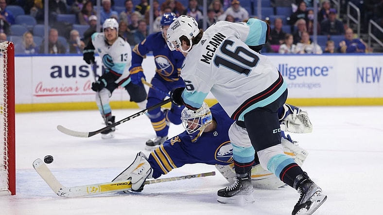 Nov 29, 2021; Buffalo, New York, USA;  Buffalo Sabres goaltender Dustin Tokarski (31) dives to try and make a save as Seattle Kraken center Jared McCann (16) takes a shot and scores during the first period at KeyBank Center. Mandatory Credit: Timothy T. Ludwig-USA TODAY Sports