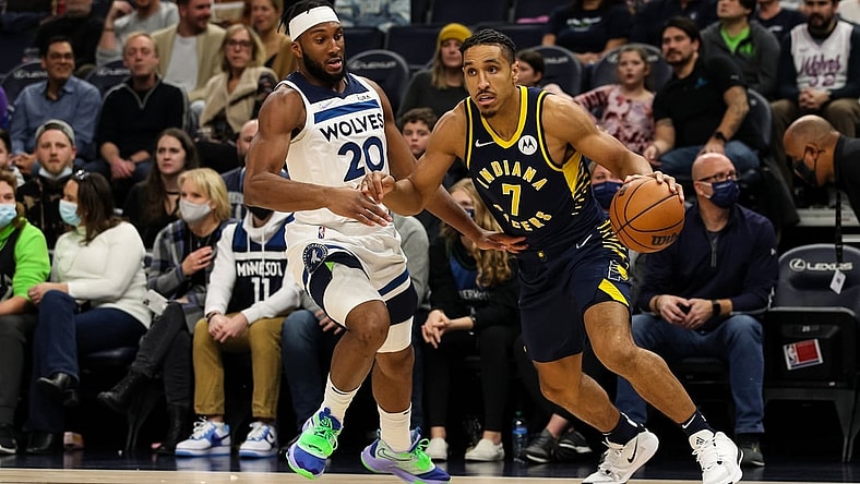 Nov 29, 2021; Minneapolis, Minnesota, USA; Indiana Pacers guard Malcolm Brogdon (7) drives to the basket while Minnesota Timberwolves forward Josh Okogie (20) defends in the first quarter at Target Center. Mandatory Credit: David Berding-USA TODAY Sports
